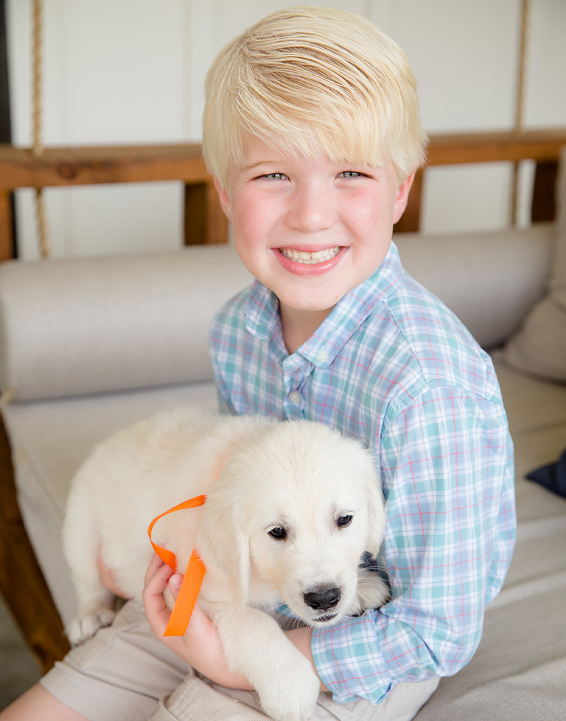a little boy holding a dog
