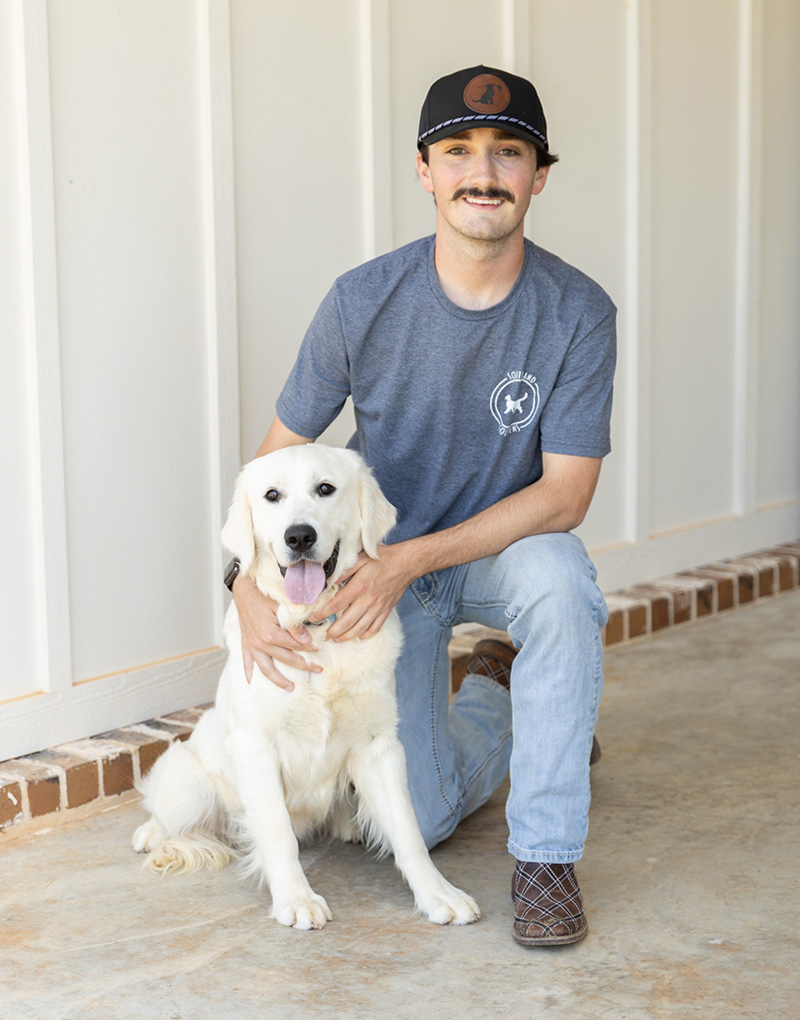 a person holding a dog posing for the camera