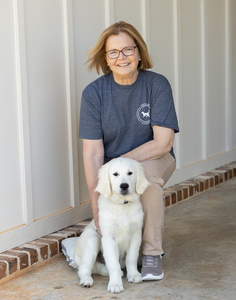 Geraldine Brooks standing next to a dog