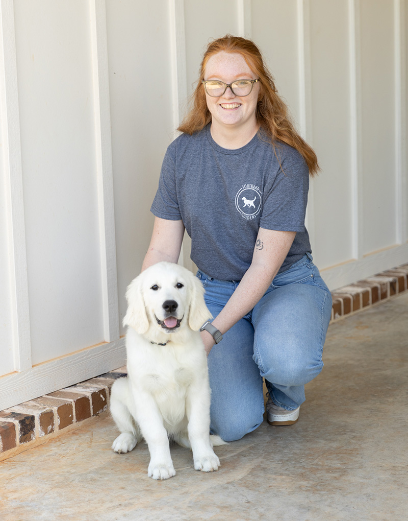 a person holding a dog posing for the camera